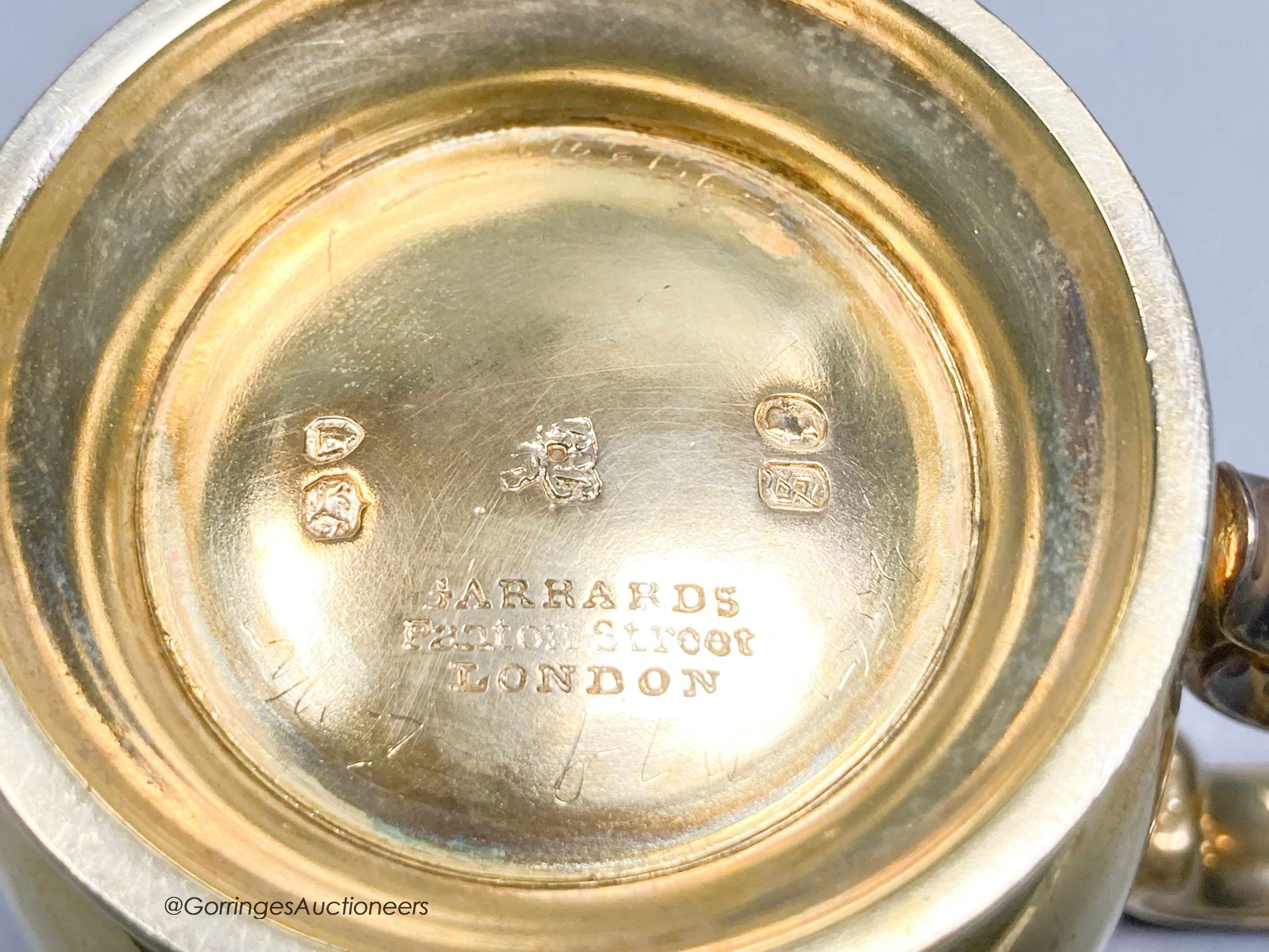 A Victorian silver gilt christening mug, by R & S. Garrard & Co, London, 1873, height 82mm, 7oz, in associated leather carrying case.